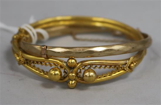 Two yellow metal hinged bangles, one with metal core.